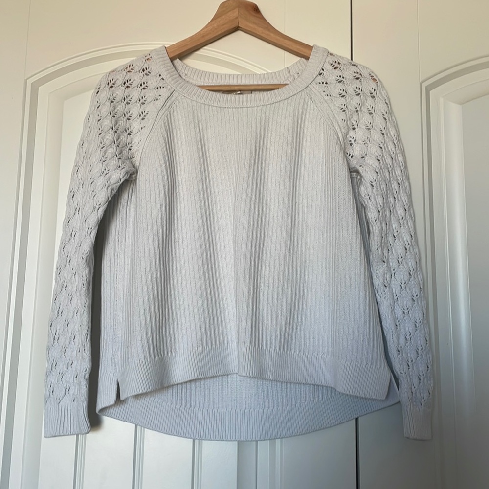 A white sweater woman’s crew neck
